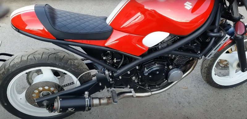 Collection of vintage motorcycle accessories including leather jackets and chrome parts from different eras